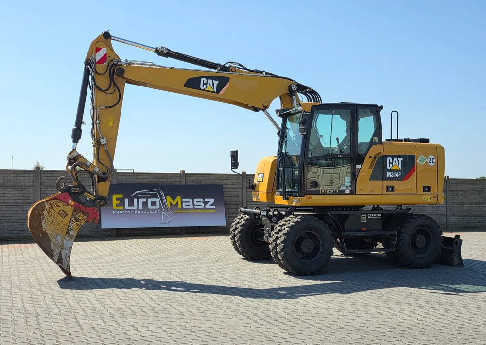 Caterpillar M314F, 2019 ROK, 3300 MTH, OIL QUICK OQ 65 - Ratastel ekskavaator: pilt 1 Caterpillar M314F, 2019 ROK, 3300 MTH, OIL QUICK OQ 65 - Ratastel ekskavaator: pilt 1