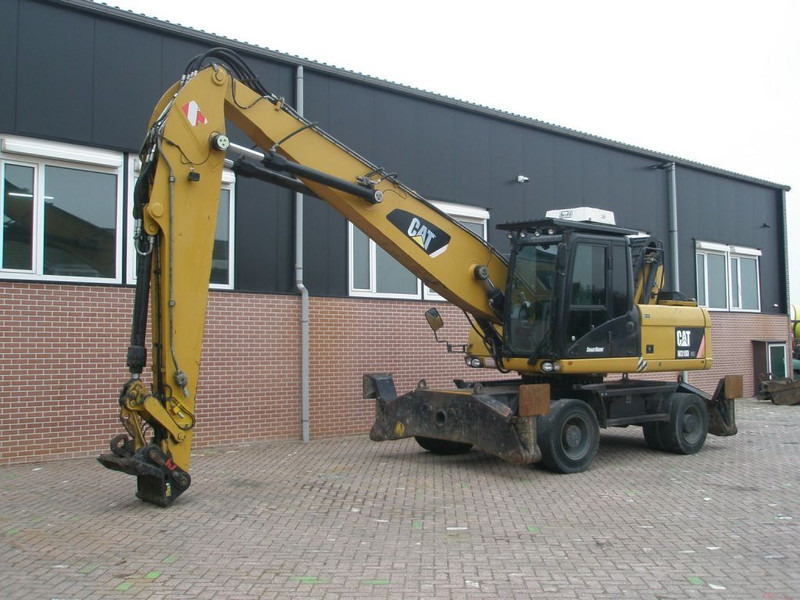 Caterpillar M318D - Ratastel ekskavaator: pilt 1 Caterpillar M318D - Ratastel ekskavaator: pilt 1