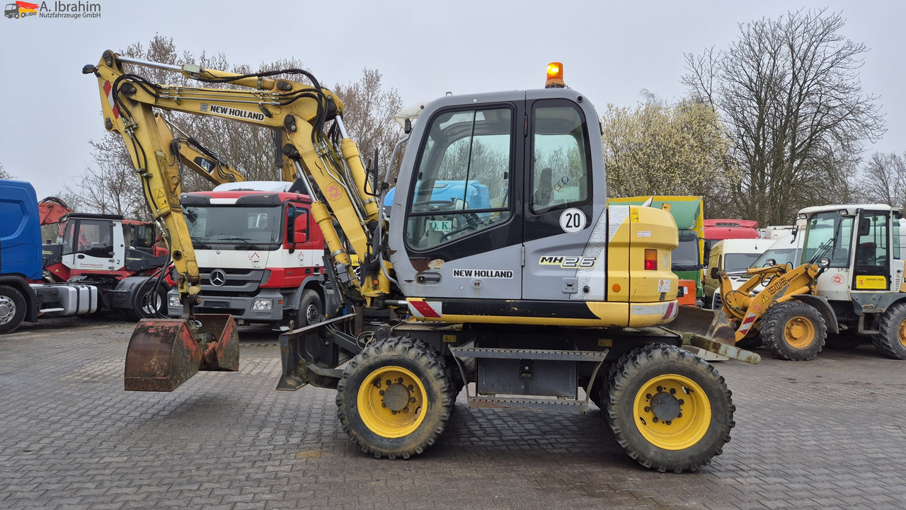 New Holland MH 2.6 Zustand gut, deutsche Maschine incl. Greifer und Dreservo - Ratastel ekskavaator: pilt 1 New Holland MH 2.6 Zustand gut, deutsche Maschine incl. Greifer und Dreservo - Ratastel ekskavaator: pilt 1
