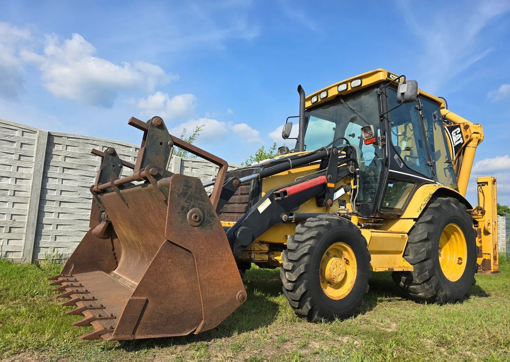 Caterpillar - Ekskavaator-laadur: pilt 1 Caterpillar - Ekskavaator-laadur: pilt 1