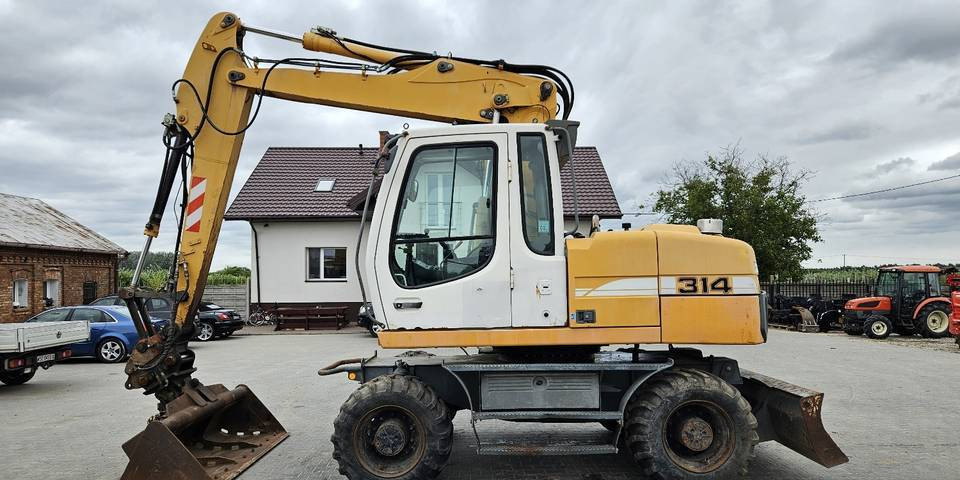 Koparka kołowa Liebherr A314 Litronic 9350 h+ 5 łyżek kołówka - Ratastel ekskavaator: pilt 1 Koparka kołowa Liebherr A314 Litronic 9350 h+ 5 łyżek kołówka - Ratastel ekskavaator: pilt 1