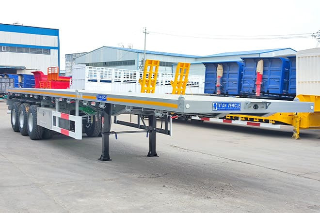 TITAN Tri Axle 40Ft Flatbed Trailer Price for Sale in Sierra Leone - Platvorm/ Madelpoolhaagis: pilt 1 TITAN Tri Axle 40Ft Flatbed Trailer Price for Sale in Sierra Leone - Platvorm/ Madelpoolhaagis: pilt 1
